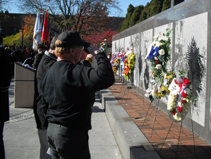 (Veterans salute during a ceremony at the Philadelphia Vietnam Veterans Memorial.  File photo by Steve Tawa)