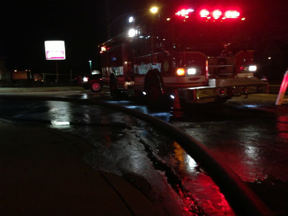 Ice covers the ground around a fire truck after a fire at a shopping center in Cheltenham. (Credit: Jim Melwert)