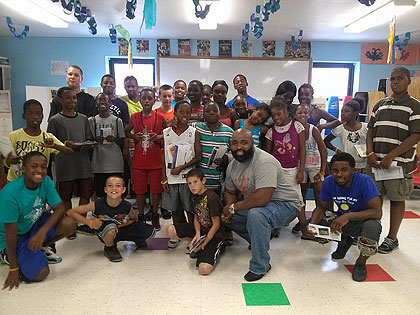 (Darren Laws, front, with some of the young people served by The Mission. Photo provided)