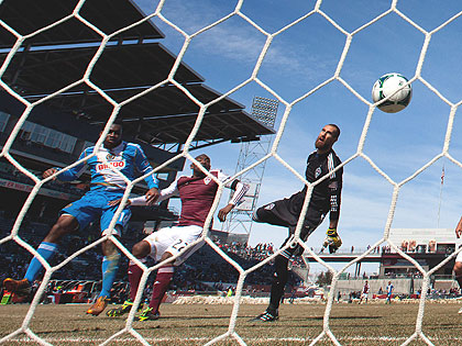 (Amobi Okugo, left, heads the ball in for a goal past Marvell Wynne and goalkeeper Matt Pickens of the Colorado Rapids on March 10th. Credit: Justin Edmonds/ Getty Images)