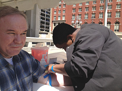 (A technician draws blood from a man at Philadelphia's first annual Kidney Action Day.  Credit: Paul Kurtz)