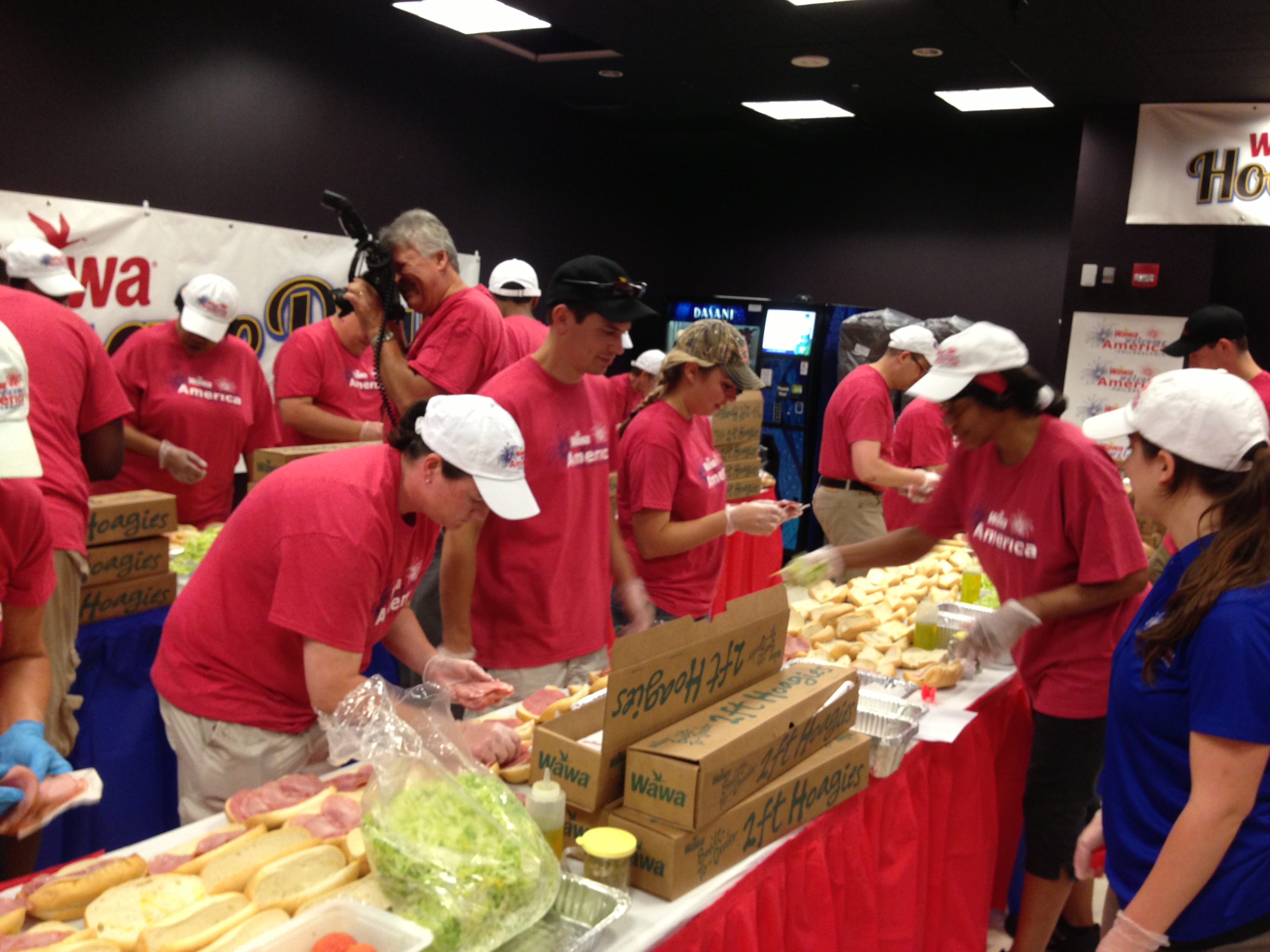 Wawa employees build a giant hoagie at the Independence Visitor Center. (Credit: Justin Udo)