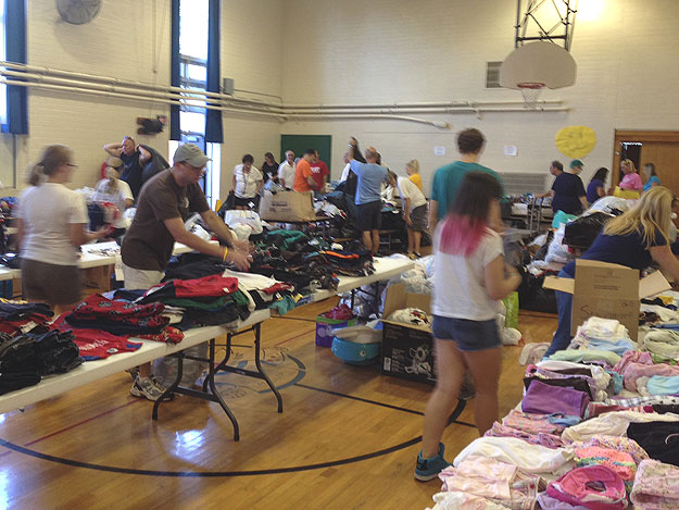 (Volunteers sort items destined for victims of the Levittown apartment fire.  Credit: Brad Segall)