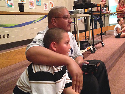 (Erasmo Santiago with his father at the Springboard Collaborative awards ceremony at McKinley Elementary School.  Credit: Cherri Gregg)