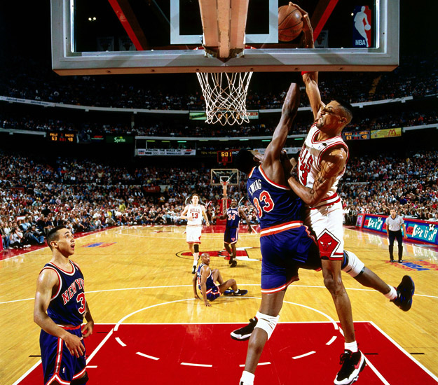 CHICAGO -  1994:  Scottie Pippen #33 of the Chicago Bulls goes for a dunk over Patrick Ewing #33 of the New York Knicks in Game six of the Eastern Conference Semifinals during the 1994 NBA Playoffs at Chicago Stadium in Chicago, Illinois.