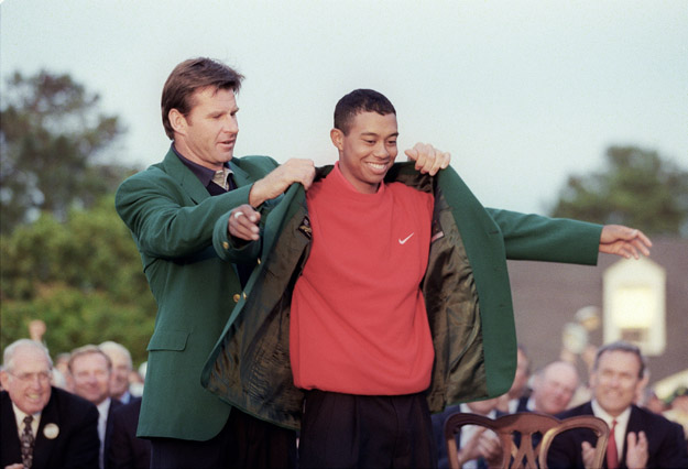 Tiger Woods (R) receives the Masters green jacket from 1996 Masters champion Nick Faldo after Woods won the 1997 Masters tournament 13 April 1997 at Augusta National Golf Club in Georgia. Woods set a new course record by shooting 18-under-par for the tournament.