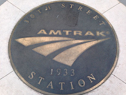 (A plaque set in a sidewalk near 30th Street Station marks its completion year, 1933.  File photo by John Ostapkovich)