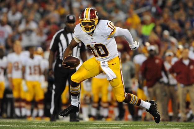 BALTIMORE, MD - AUGUST 23:  Quarterback Robert Griffin III #10 of the Washington Redskins scrambles during a preseason game against the Baltimore Ravens at M&T Bank Stadium on August 23, 2014 in Baltimore, Maryland.  