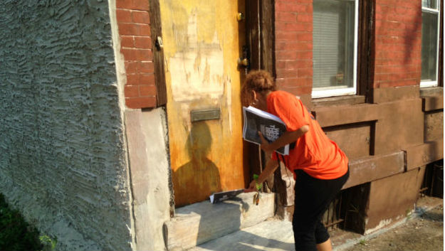 Philadelphia CeaseFire organizer goes door to door leaving fliers. (credit: Cherri Gregg)