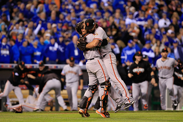 KANSAS CITY, MO - OCTOBER 29:  Buster Posey #28 and Madison Bumgarner #40 of the San Francisco Giants celebrate after defeating the Kansas City Royals to win Game Seven of the 2014 World Series by a score of 3-2 at Kauffman Stadium on October 29, 2014 in Kansas City, Missouri.  (Photo by Jamie Squire/Getty Images)