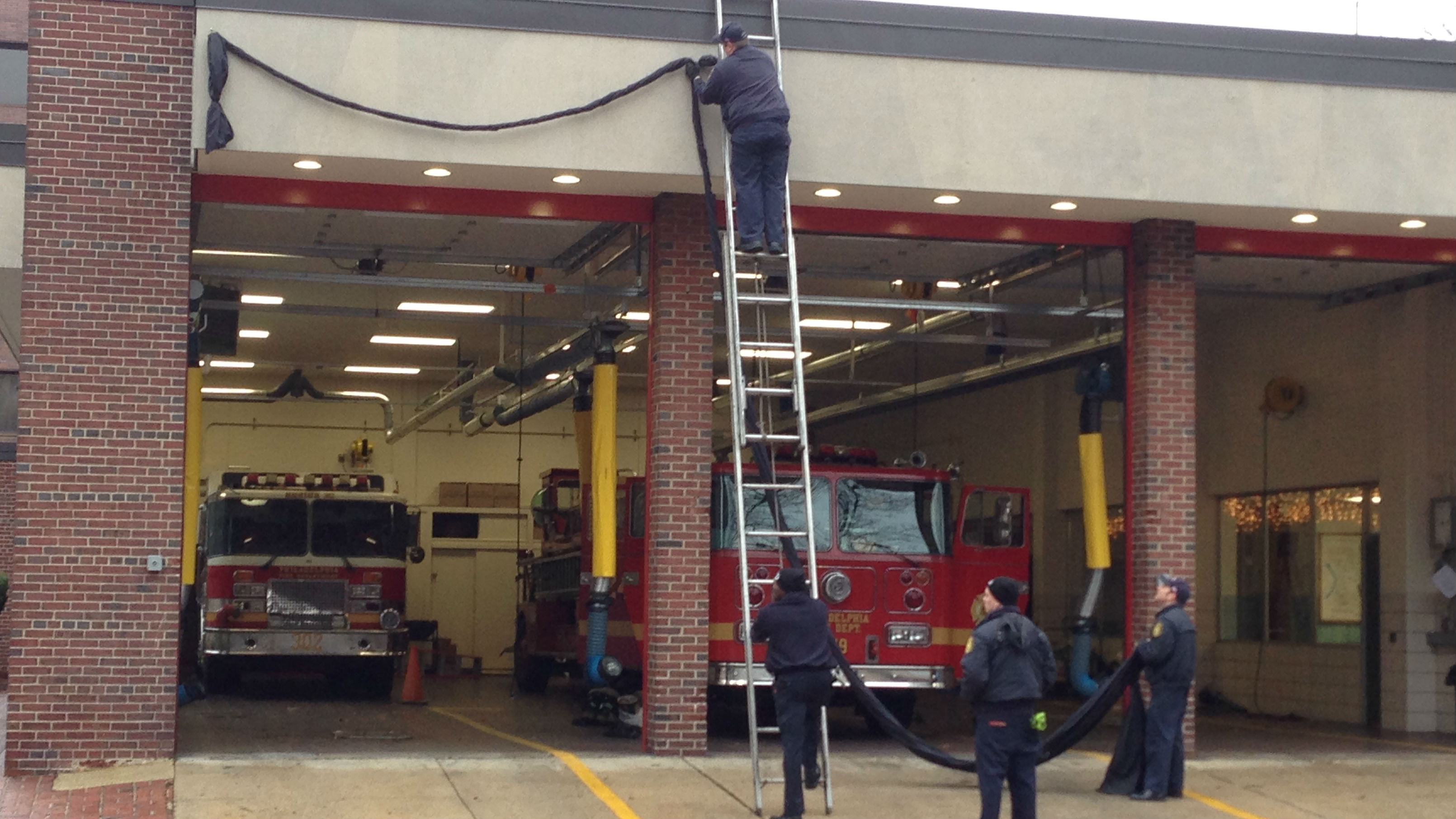 Firefighters put up a black bunting at the station on 4th and Arch later Tuesday morning. (Credit: Tony Hanson)