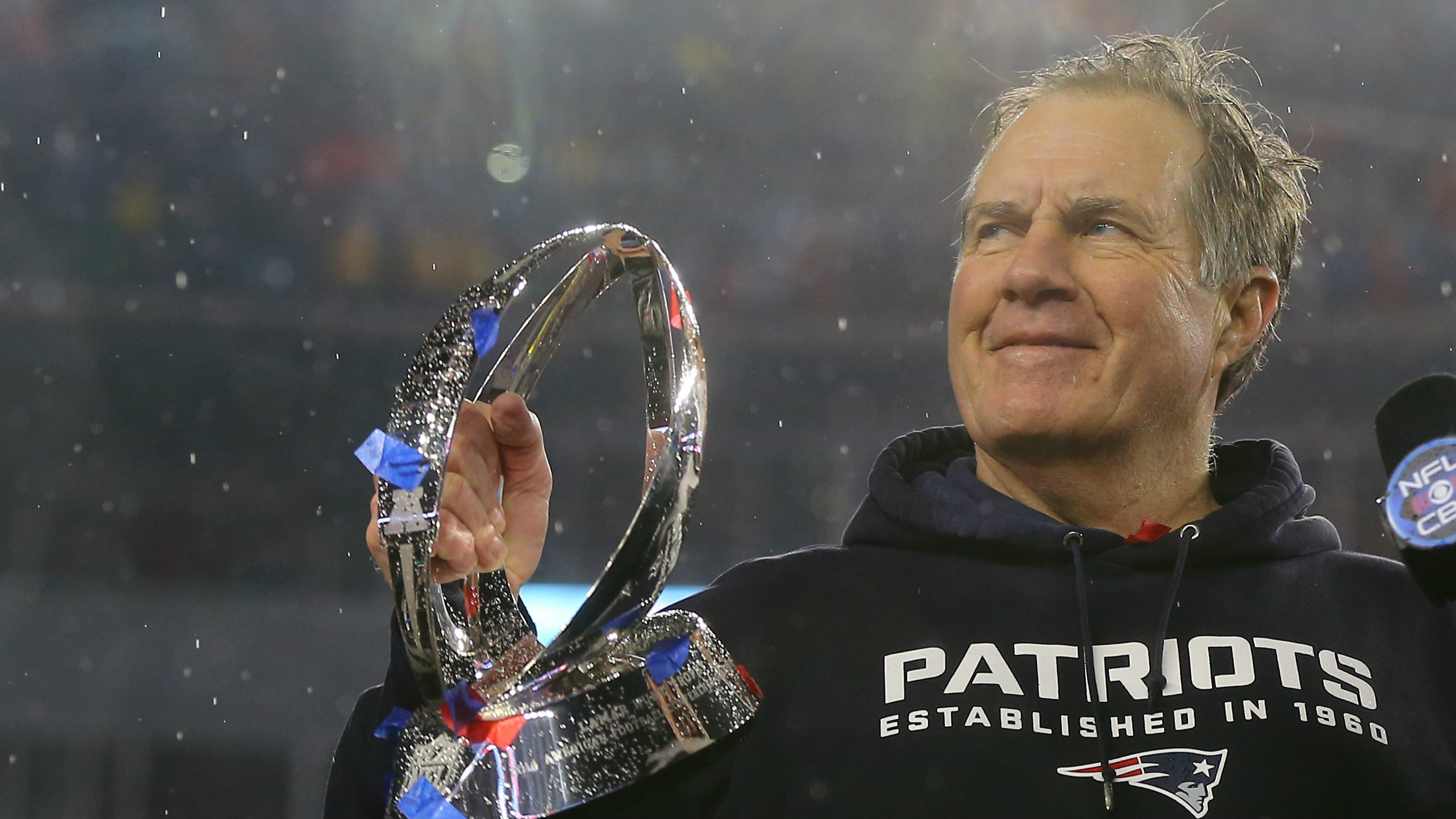 FOXBORO, MA - JANUARY 18: Head coach Bill Belichick of the New England Patriots holds up the Lamar Hunt Trophy after defeating the Indianapolis Colts in the 2015 AFC Championship Game at Gillette Stadium on January 18, 2015 in Foxboro, Massachusetts. The Patriots defeated the Colts 45-7. (Photo by Elsa/Getty Images)