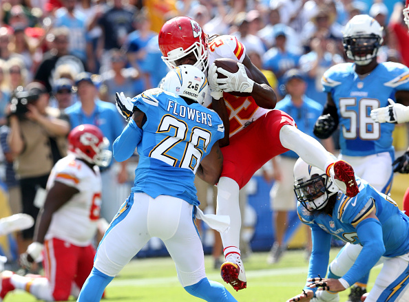 SAN DIEGO, CA - OCTOBER 19:  Running back Jamaal Charles #25 of the Kansas City Chiefs dives around cornerback Brandon Flowers #26 of the San Diego Chargers to score a touchdown to finish a 16 yard run in the second quarter at Qualcomm Stadium on October 19, 2014 in San Diego, California.  (Photo by Stephen Dunn/Getty Images)