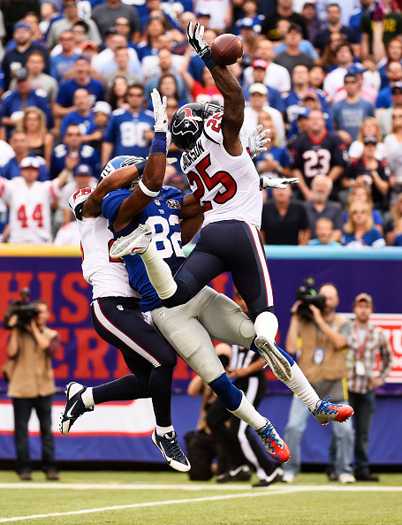 EAST RUTHERFORD, NJ - SEPTEMBER 21:   Kareem Jackson #25 of the Houston Texans breaks up a pass intended for  Rueben Randle #82 of the New York Giants in the second quarter at MetLife Stadium on September 21, 2014 in East Rutherford, New Jersey.  (Photo by Alex Goodlett/Getty Images)