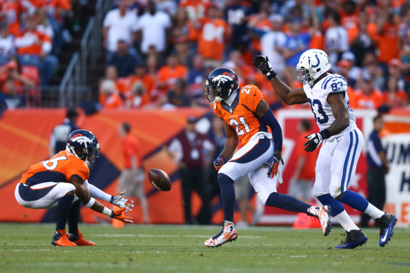DENVER, CO - SEPTEMBER 7:  Free safety Rahim Moore #26 of the Denver Broncos intercepts a pass deflected by cornerback Aqib Talib #21 intended for tight end Dwayne Allen #83 of the Indianapolis Colts that was during a game at Sports Authority Field at Mile High on September 7, 2014 in Denver, Colorado.  (Photo by Jeff Gross/Getty Images)