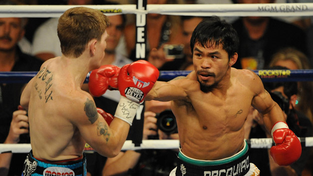 Manny Pacquiao (R) of the Philippines lands a punch on the face of Ricky Hatton of England.