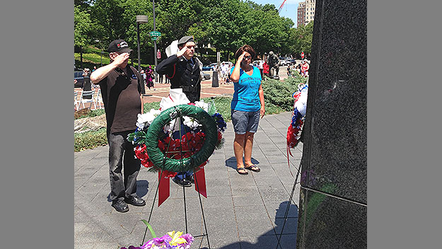 (A niece of Cpl. Robert Higgins takes part in a wreath-laying ceremony at the Korean War Veterans Memorial.  Photo by Marcy Norton)