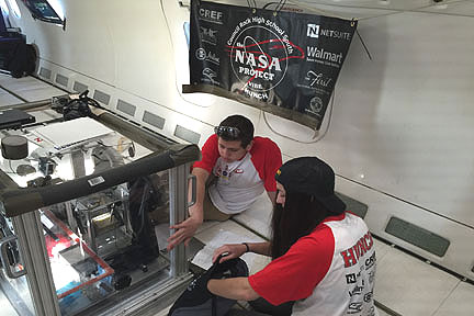 (Council Rock HS "VIBE" ground crew workers Samuel Preissman and Julia Termine make sure the experiment is running properly before it is handed off to a plane crew who will fly it in simulated spaceflight conditions.  Photo provided)