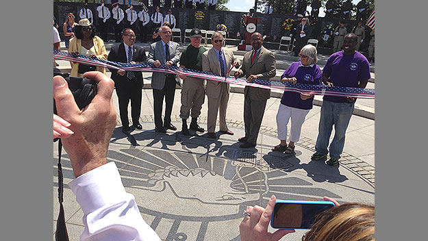 (Mayor Nutter, third from right, joins in a ribbon-cutting to officially reopen the city's Vietnam War memorial after a seven-year makeover.  Photo by Marcy Norton)