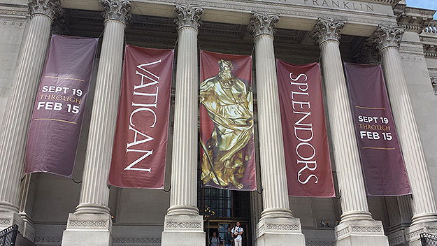 (Banners on the Franklin Institute, near where Pope Francis will be holding outdoor mass, announce the display of Vatican items.  Photo by Mike Dougherty)