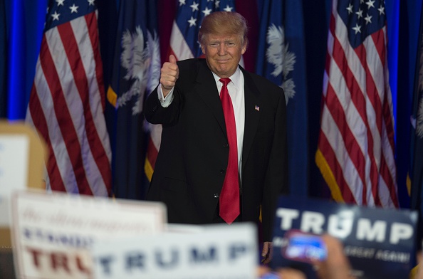 Republican presidential candidate Donald Trump celebrates winning the South Carolina primary in Spartanburg, South Carolina, February 20, 2016. Republican presidential frontrunner Donald Trump grabbed a big win in the South Carolina primary on February 20, 2016. The 69-year-old Trump captured about a third of the votes, according to early counts, but all major networks projected he was the winner. / AFP / JIM WATSON (Photo credit should read JIM WATSON/AFP/Getty Images)