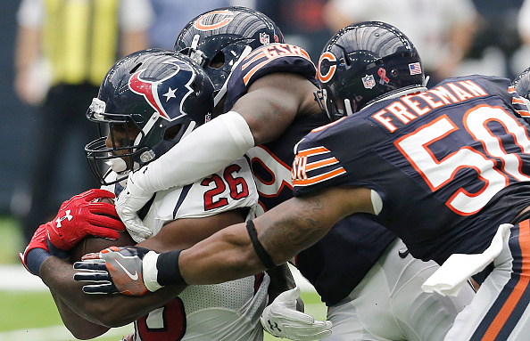 HOUSTON, TX - SEPTEMBER 11: Lamar Miller #26 of the Houston Texans is tackled by Jerrell Freeman #50 of the Chicago Bears in the second half at NRG Stadium on September 11, 2016 in Houston, Texas. Texans won 23 to 14. (Photo by Thomas B. Shea/Getty Images)