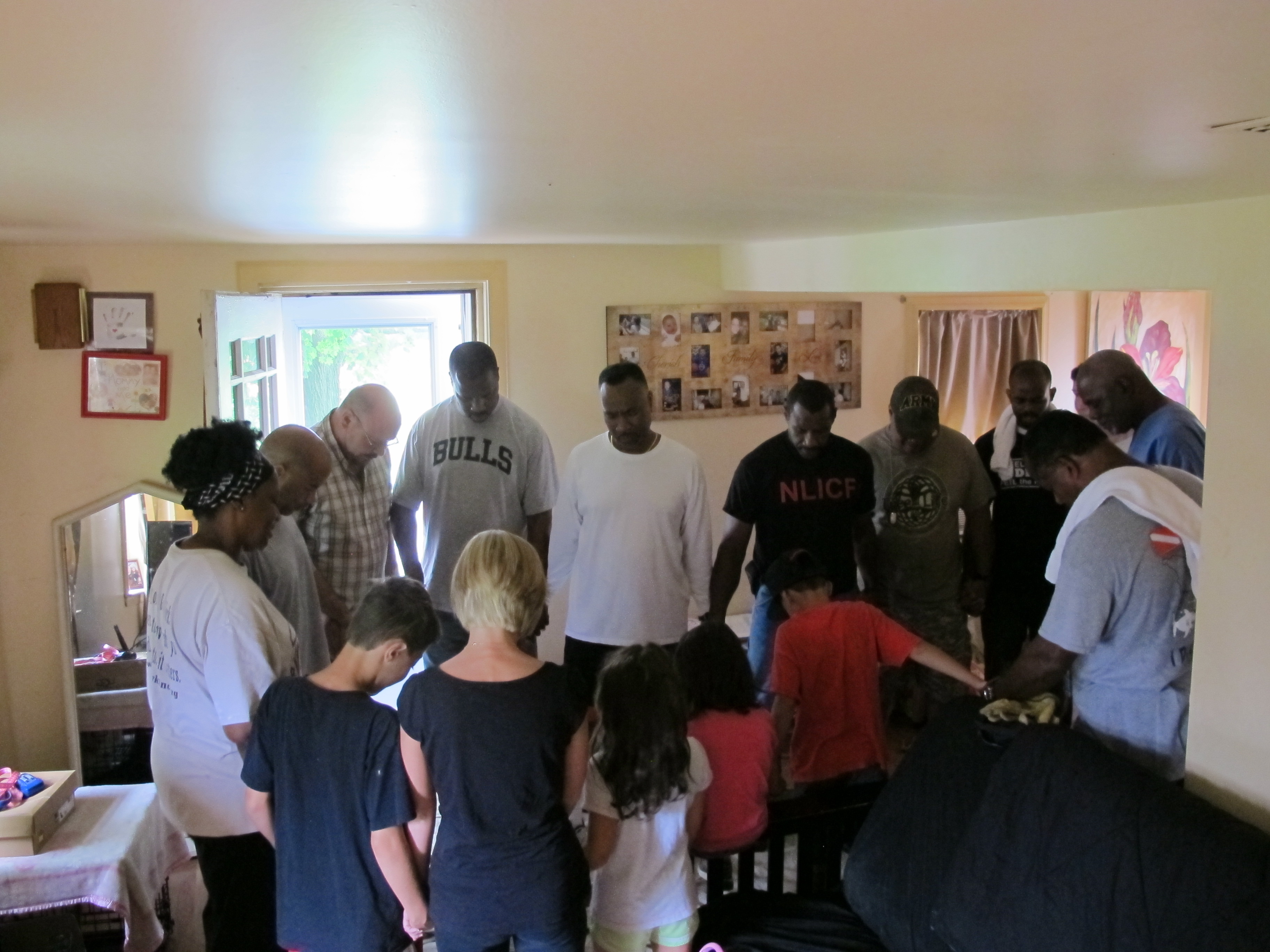 Good Works Volunteers praying with home repair recipient. (provided by Good Works)